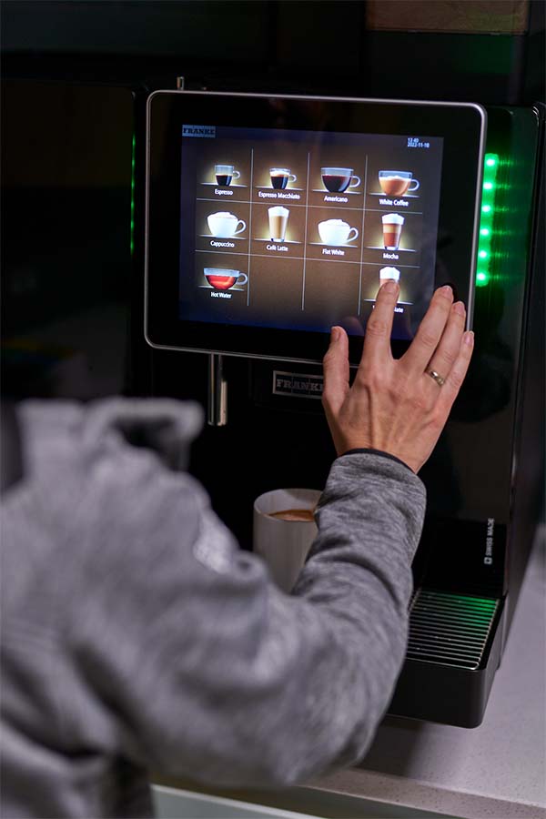 person using coffee machine