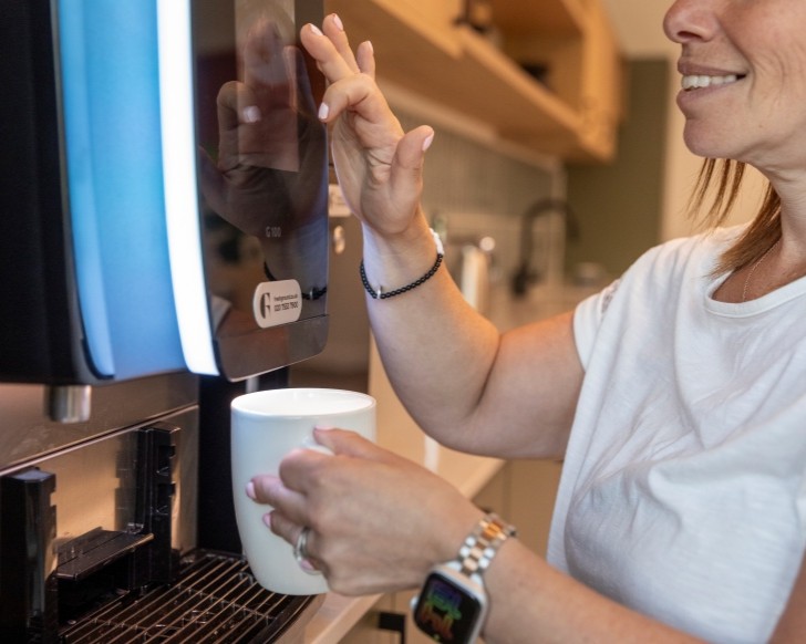 Office worker using a coffee machine